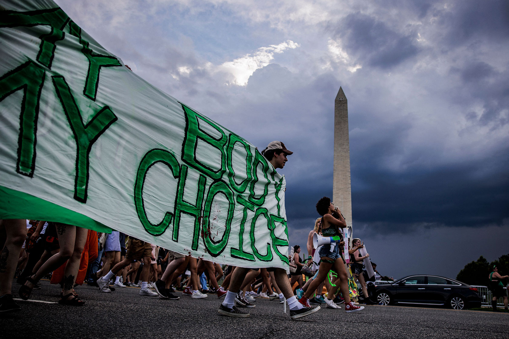 Abortion rights activists march past the Washington Monument.