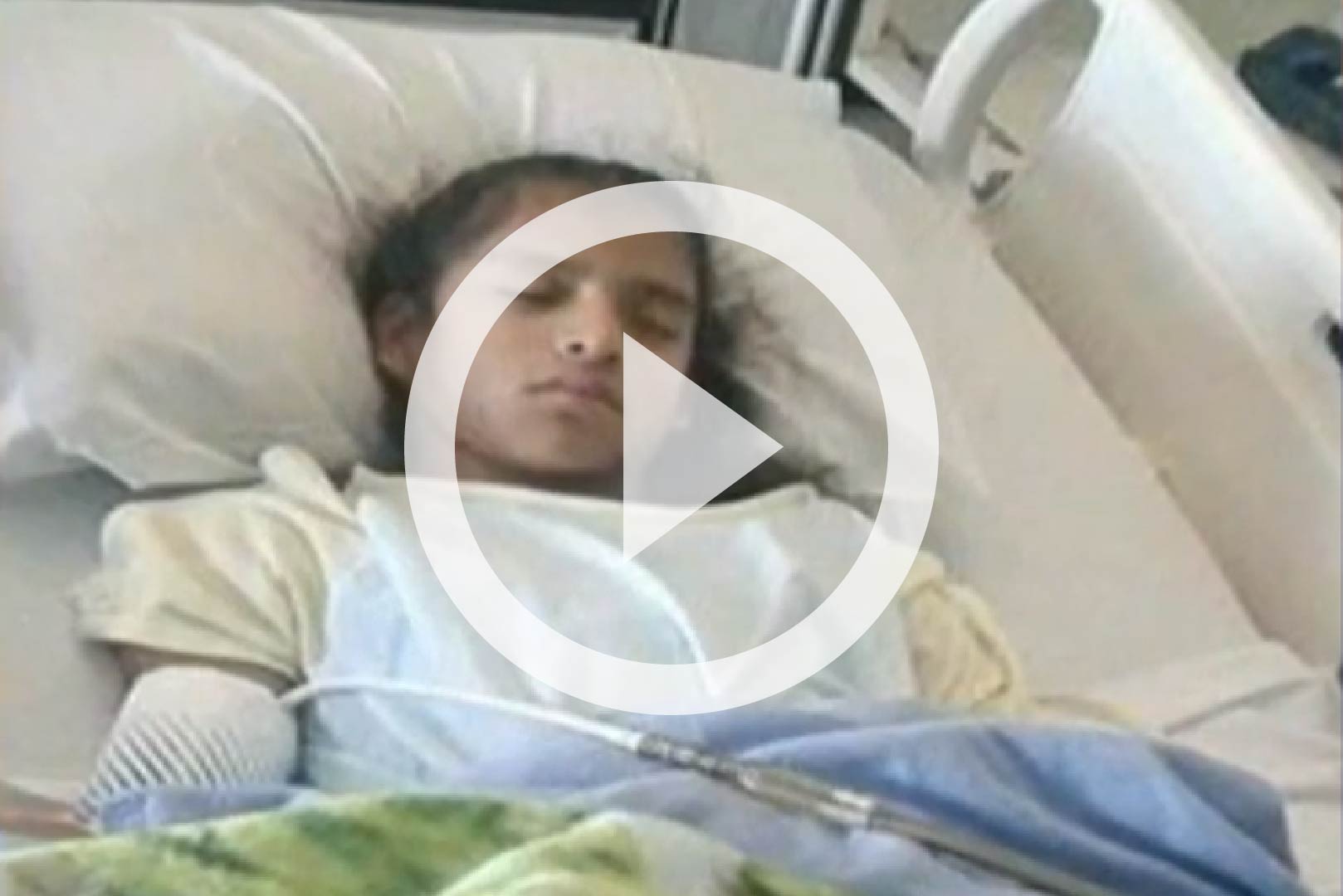 Rosa Maria Hernandez lies in a hospital bed.