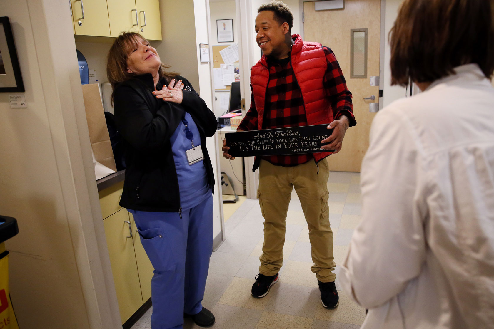 A man and woman are pictured in a room at the Violence Advocacy Program offices at Boston Medical Center in Boston.