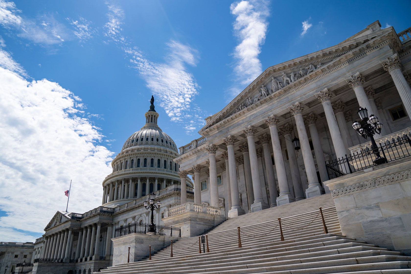 The U.S. Capitol building stands against a partly cloudy sky in Washington.