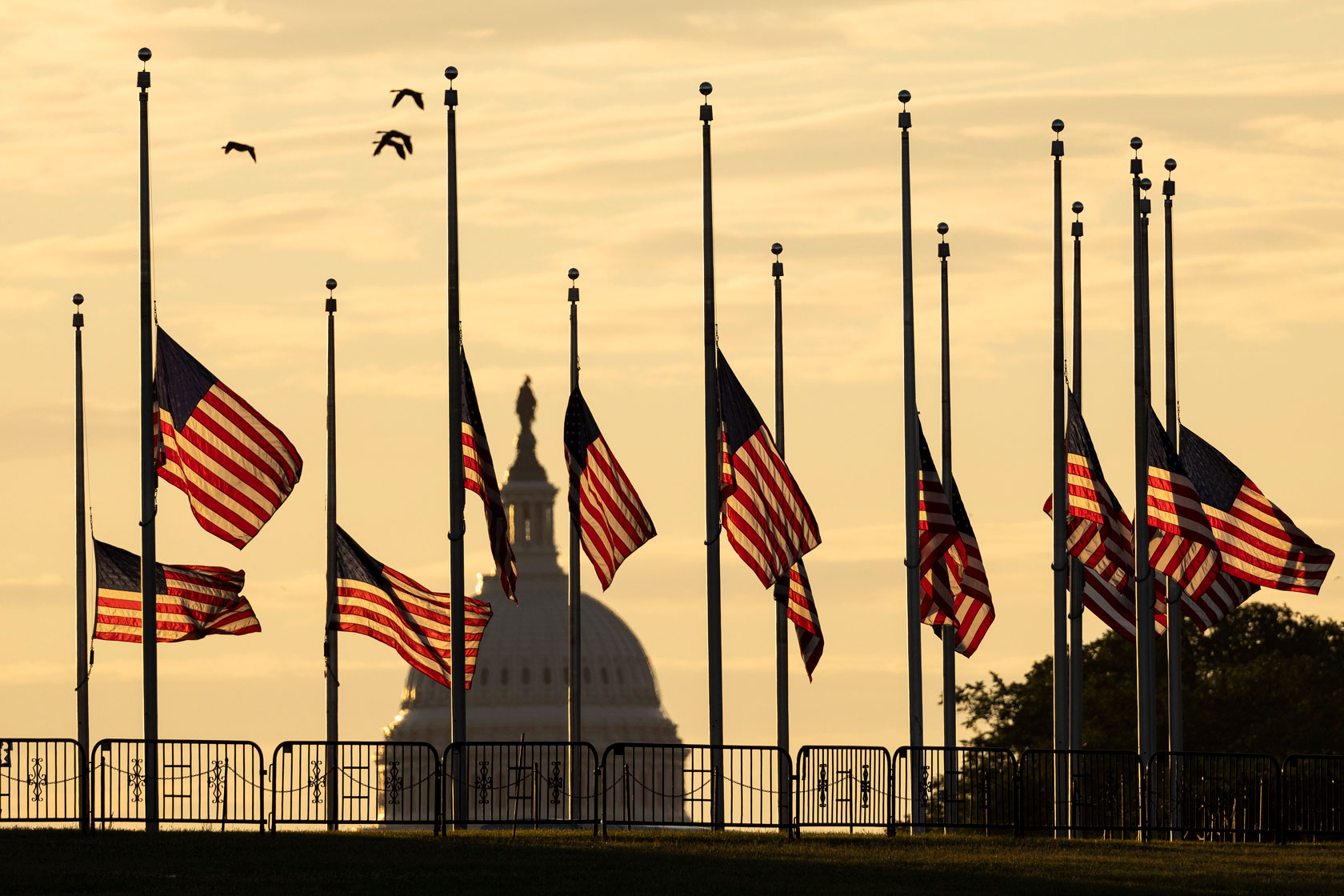 American flags are flown at half-staff at the base of the Washington Monument in Washington, D.C.