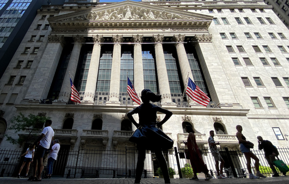 People make their way near to The New York Stock Exchange, on July 12, 2022 in New York.