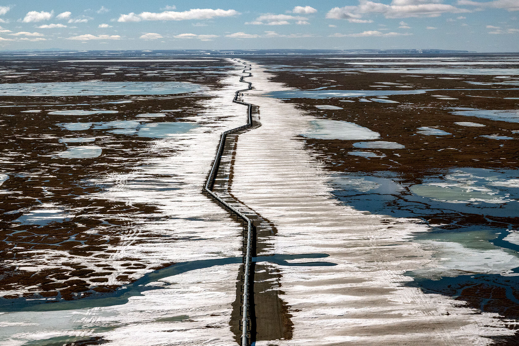 An oil pipeline stretches across the landscape outside Prudhoe Bay, Alaska.