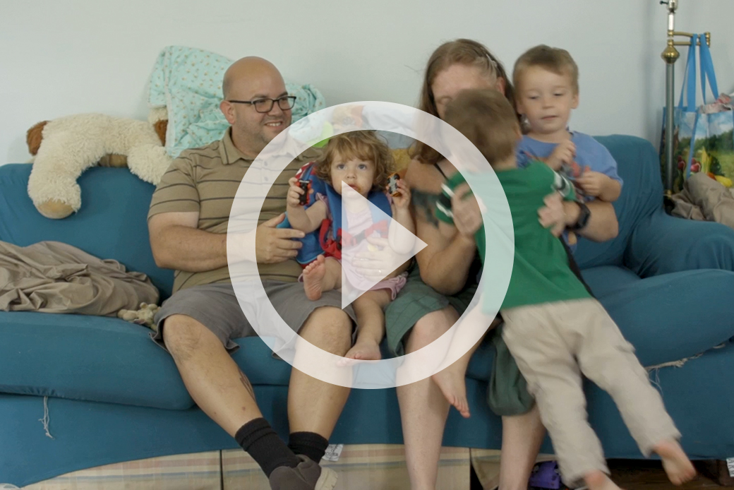 Family, featured in video, sitting on couch