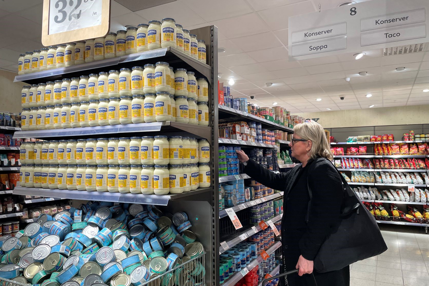 Woman reaching for food on shelf