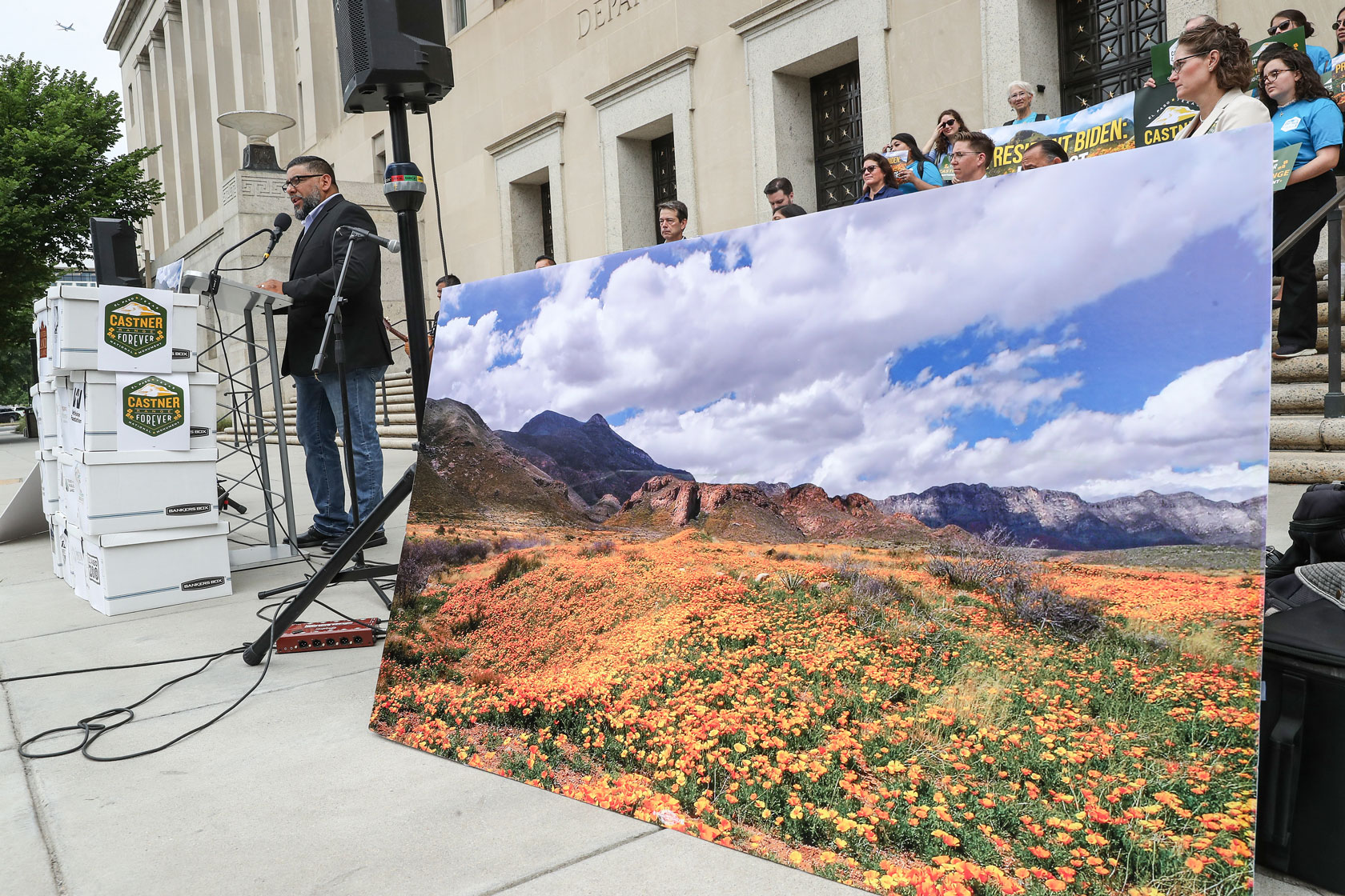 Image showing a man speaking in front of the Department of the Interior