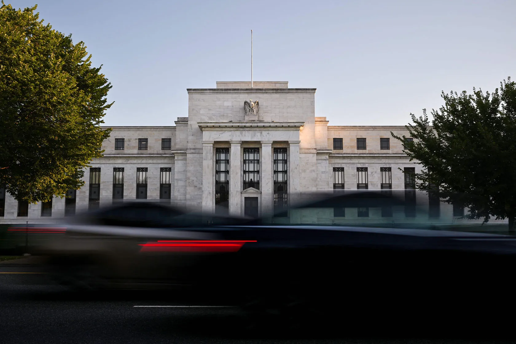 Cars drive past the U.S. Federal Reserve building in Washington, D.C.
