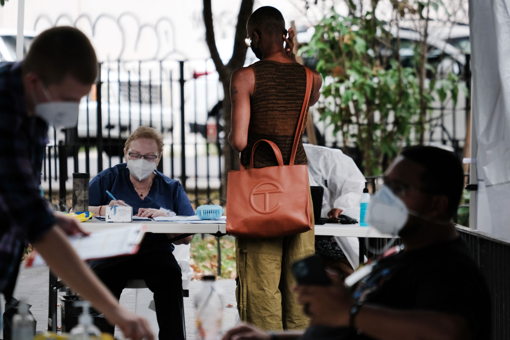 Health care workers work at intake tents in New York City.