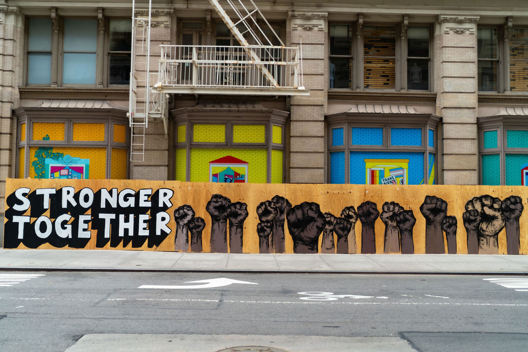 A board in front of a storefront says,