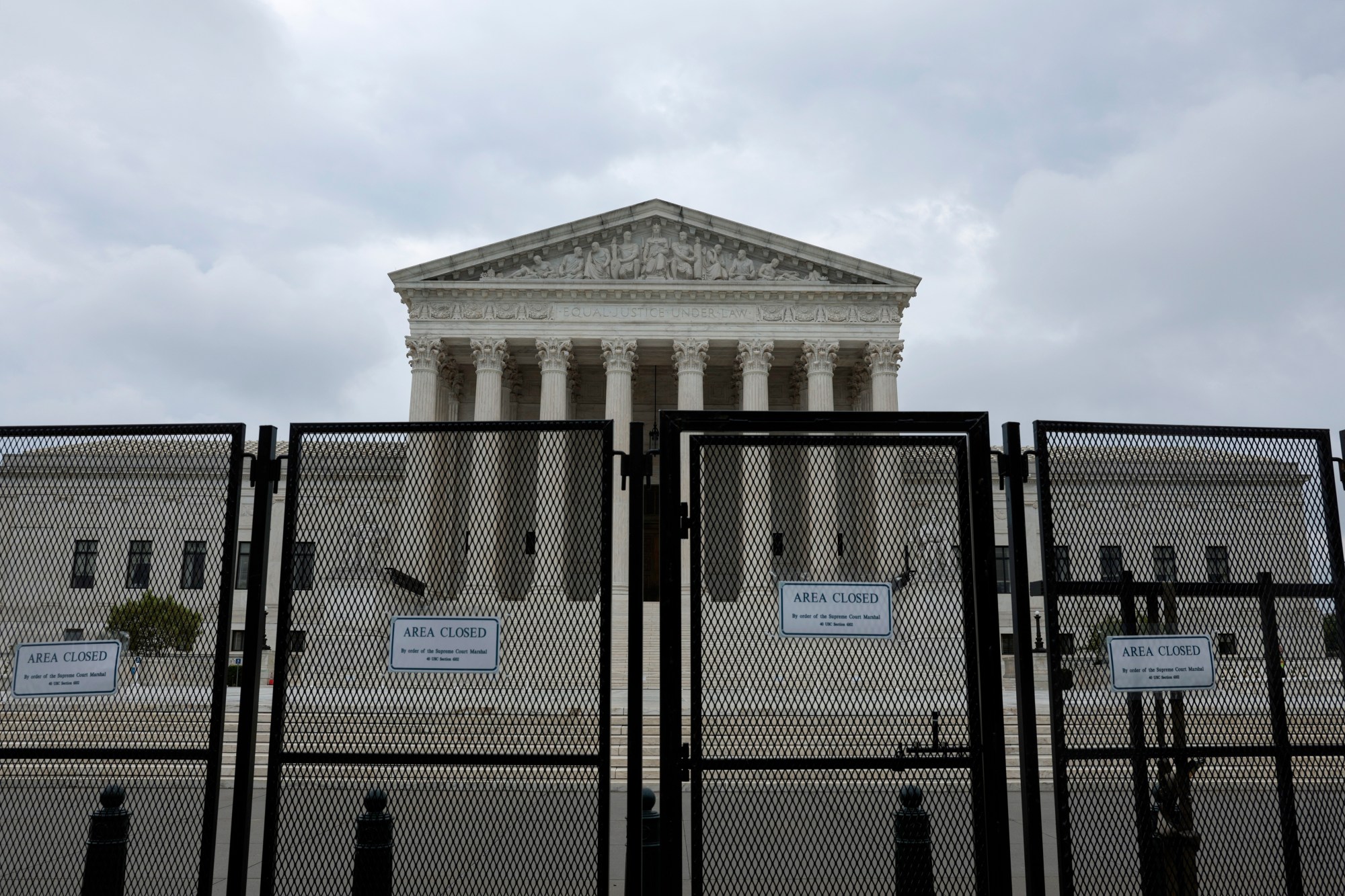 Photo shows the U.S. Supreme Court behind a security fence.