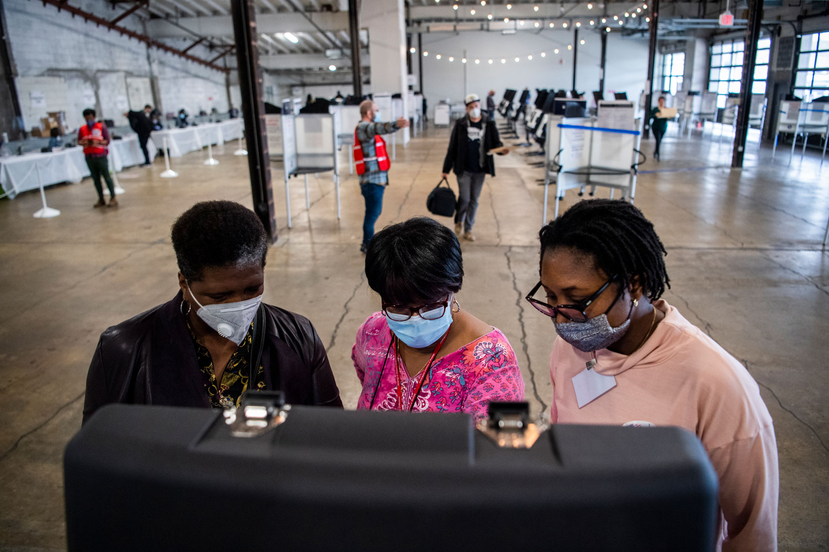 Poll workers assist a voter in casting a ballot in Washington, D.C.