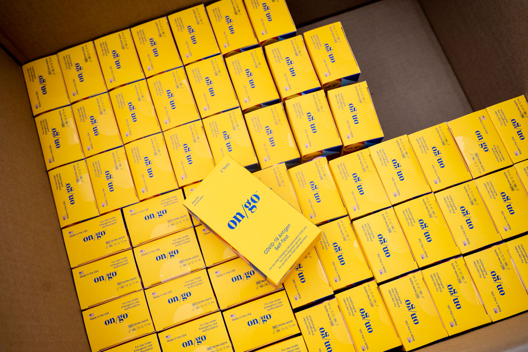 A box of yellow COVID-19 test kits is seen at the offices of the California Department of Public Health.
