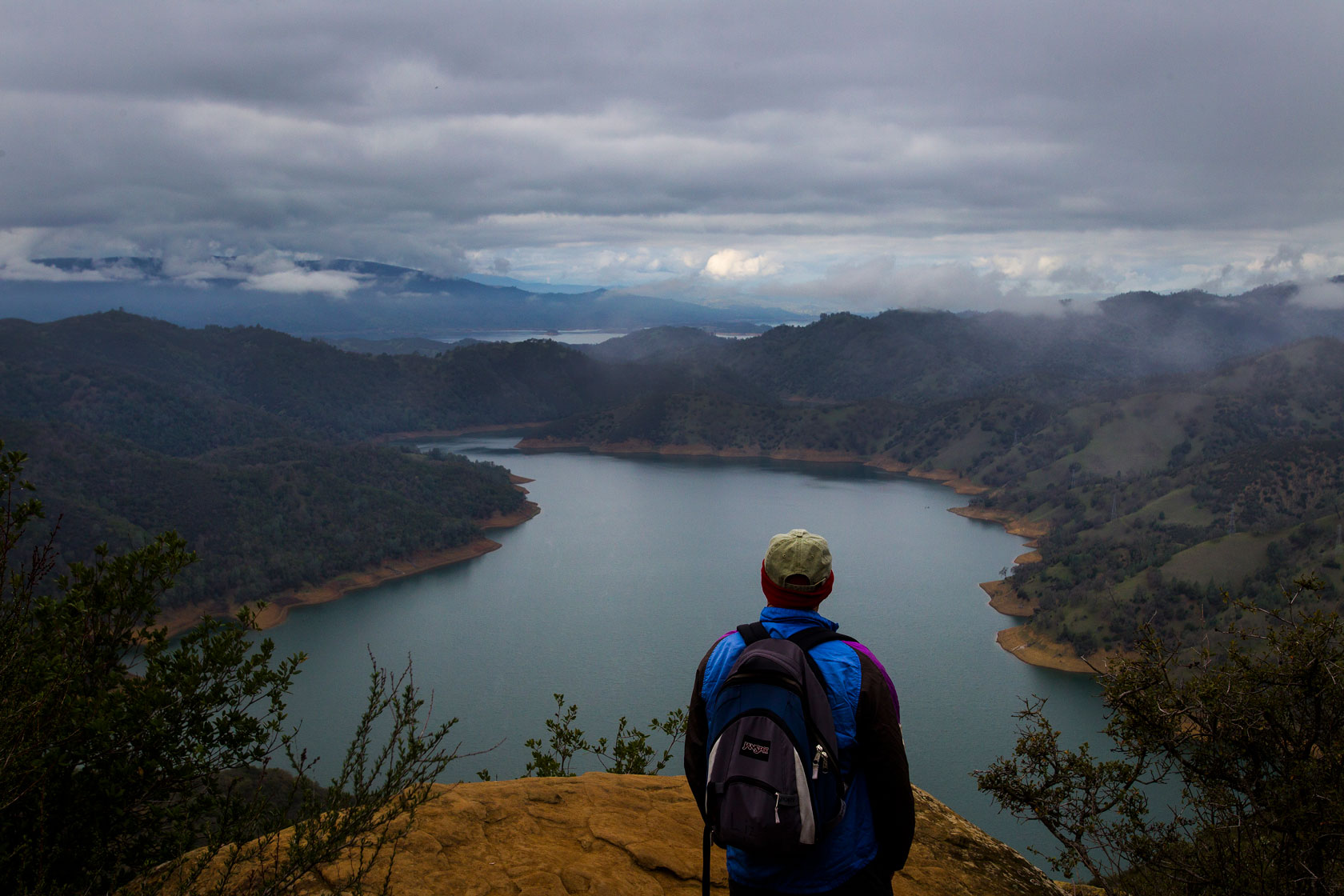 A hiker looks toward Lake Berryessa in Northern California.