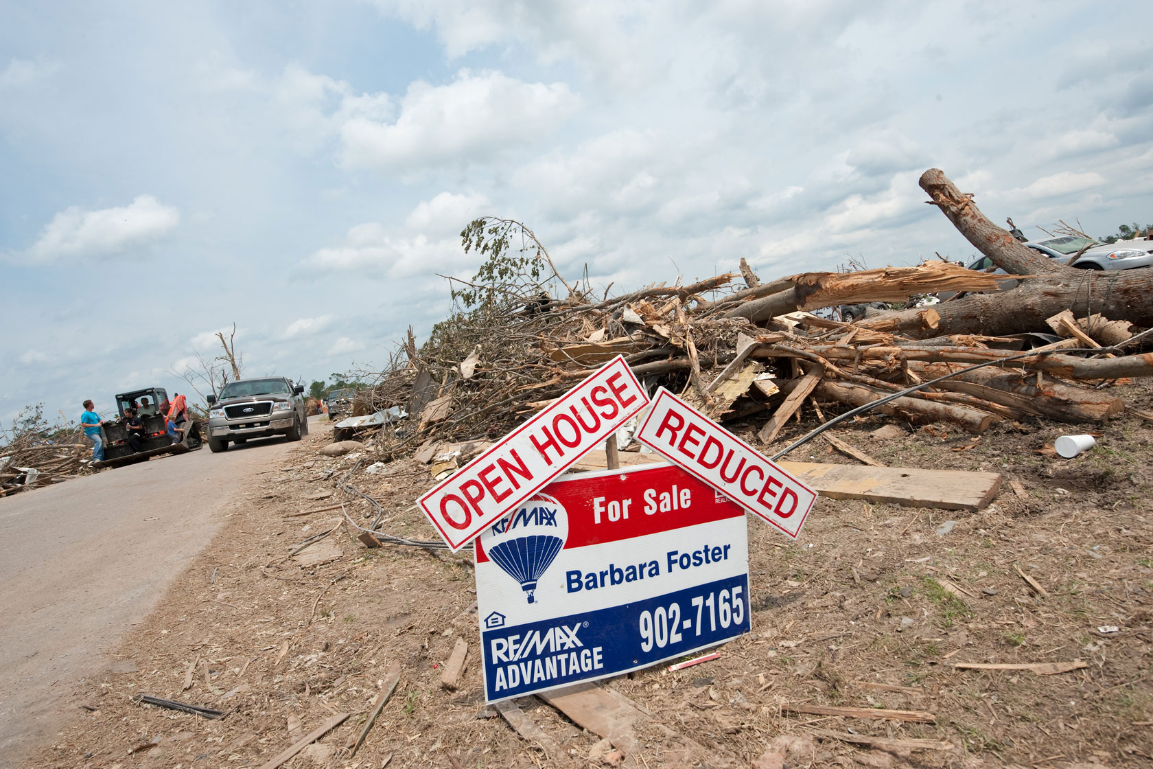 A for-sale sign is up in front of the remains of a house, which was destroyed due to a tornado in Concord, Alabama, on May 1, 2011.