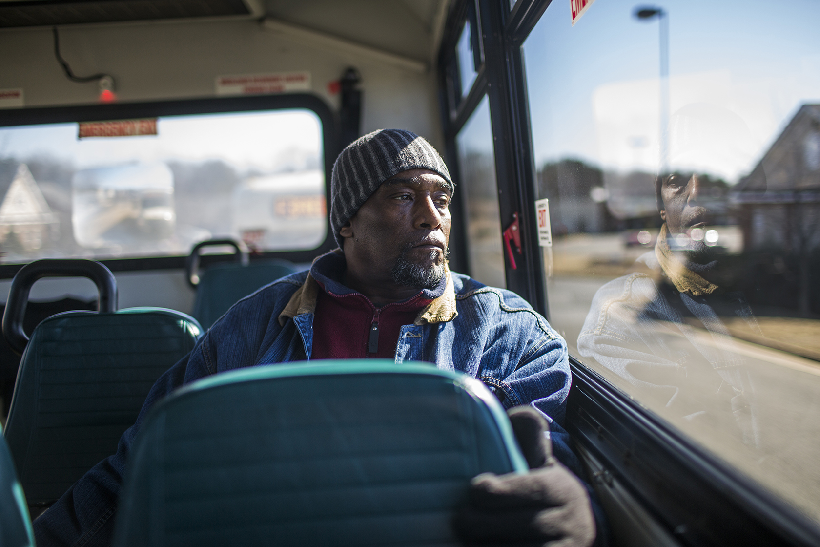 Man on bus looking out window