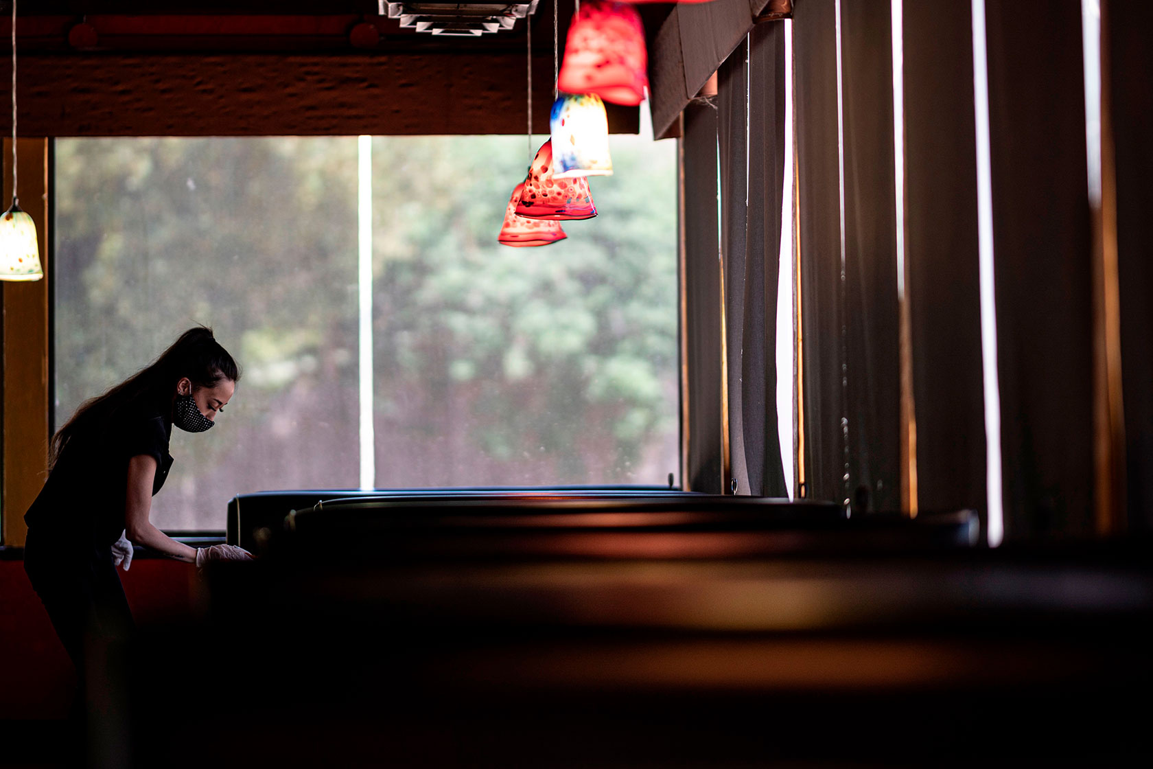 A waitress disinfects a table in a Stillwater, Oklahoma, restaurant.