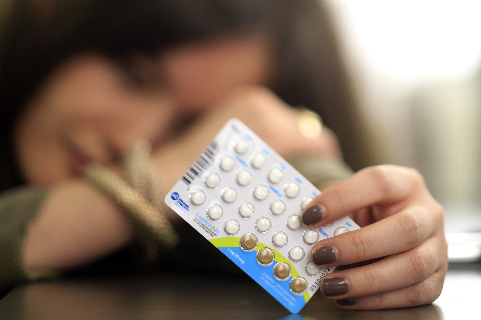 Person holding birth control pills