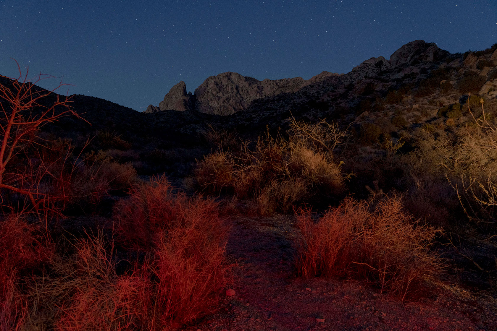 Photo shows Avi Kwa Ame at night, against a background of a starry sky.