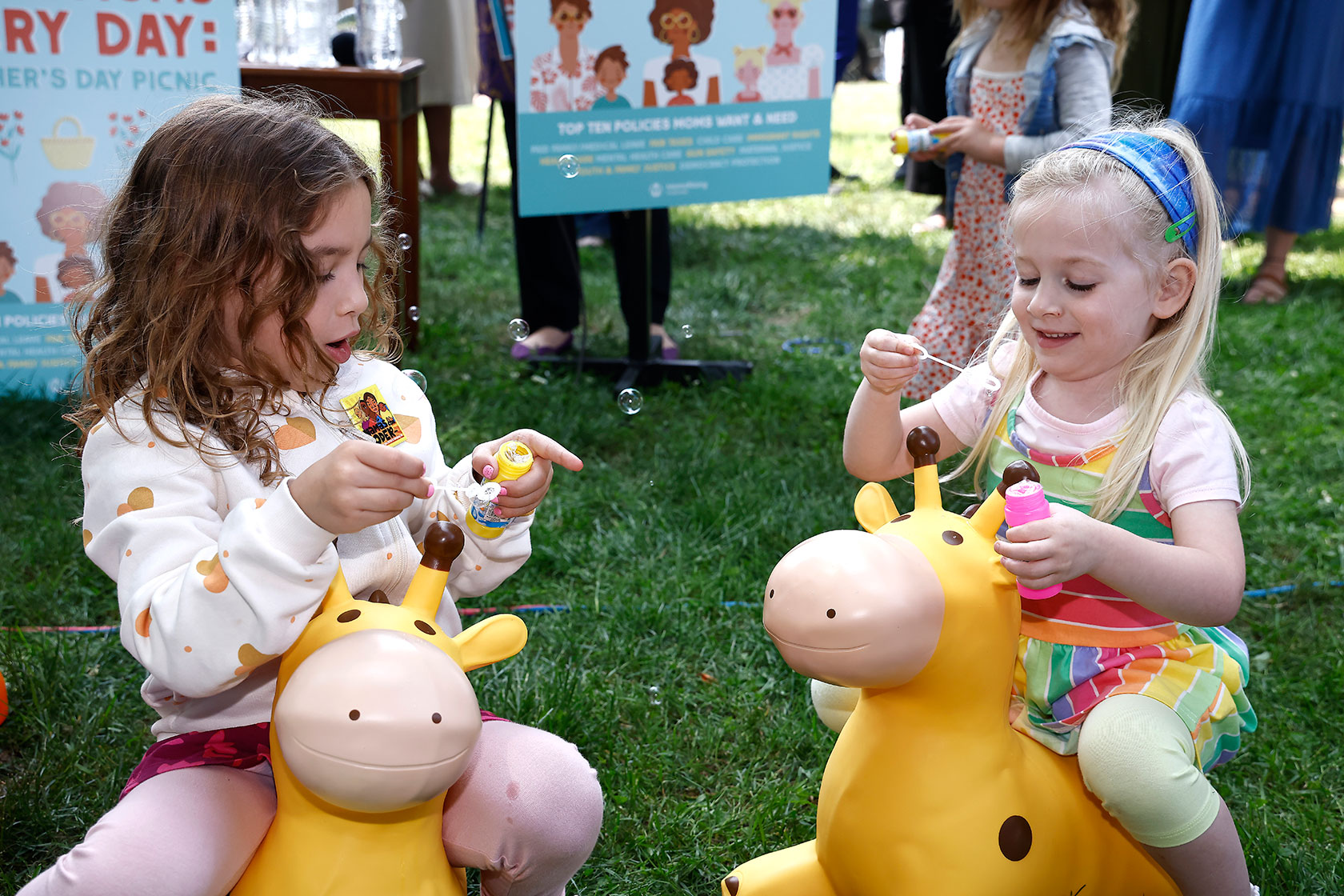 Children and their parents gather at a picnic on Capitol Hill.