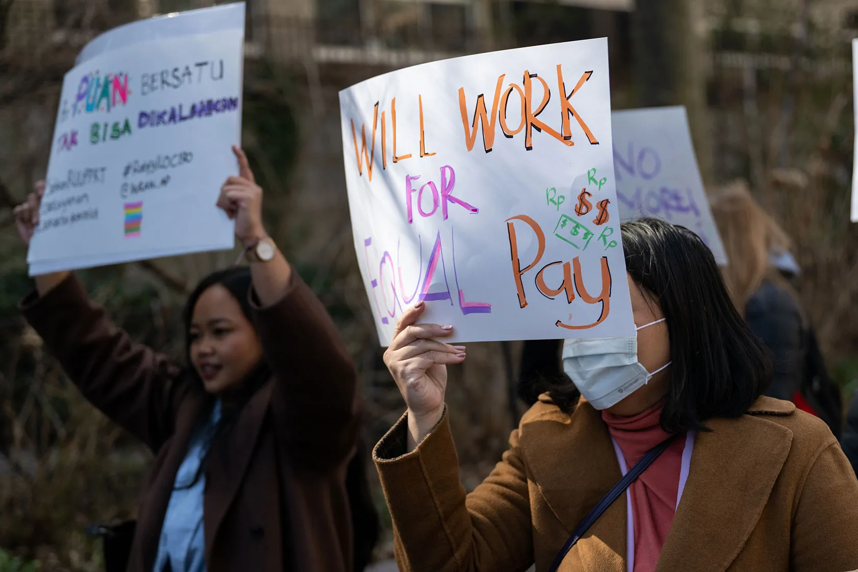 Women protest for equal pay at a rally on International Women’s Day outside the United Nations building.