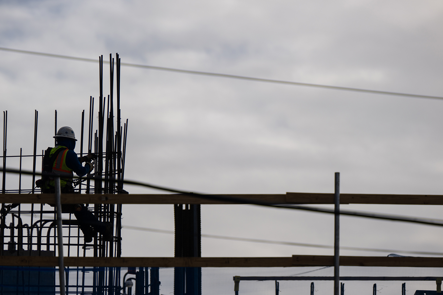 Worker on building against sky