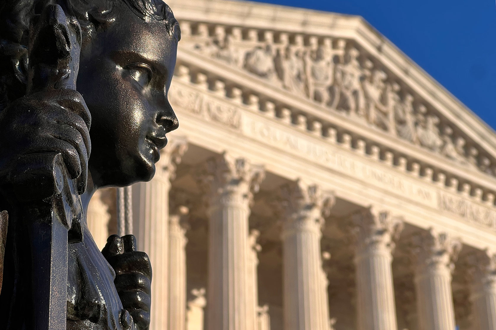 A statue stands in front of the U.S. Supreme Court building in Washington, D.C.