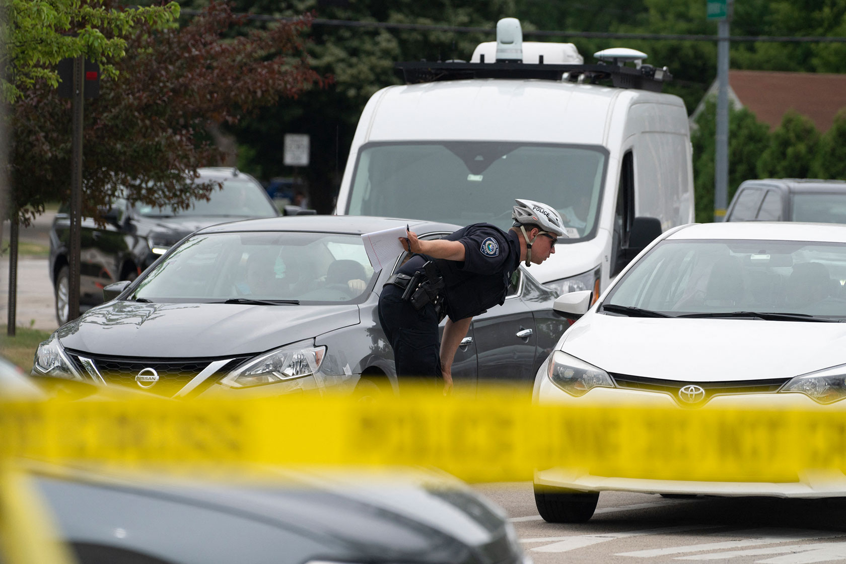 A police officer directs traffic in Highland Park, Illinois.