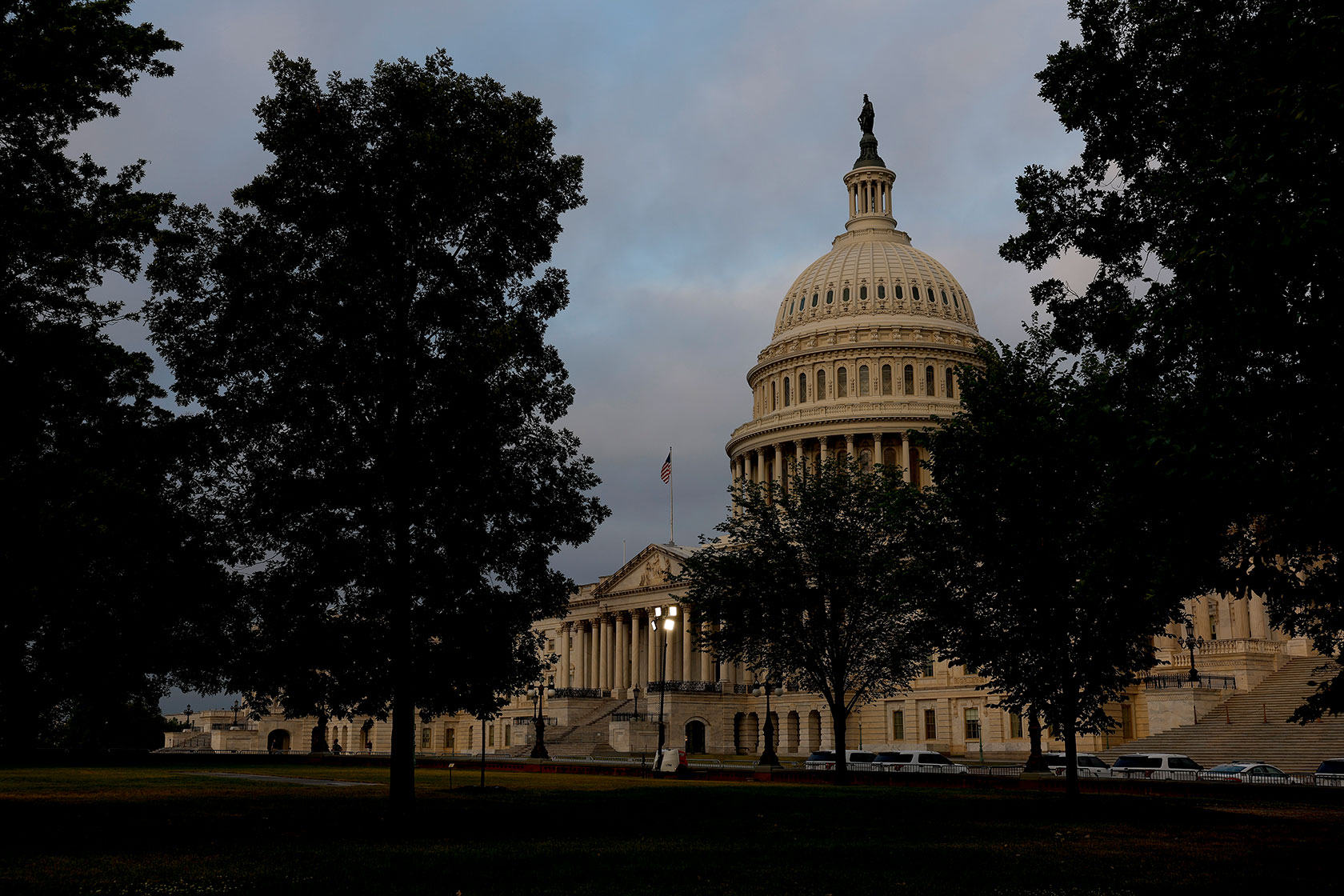 The sun rises behind the U.S. Capitol building.