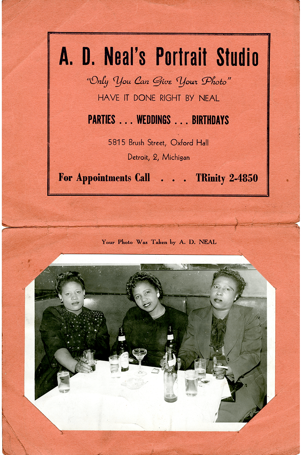 Souvenir card showing three people photographed in a booth at Uzziel Lee’s Sensation Lounge and Dining Room, taken by A.D. Neal's Portrait Studio, circa 1947.