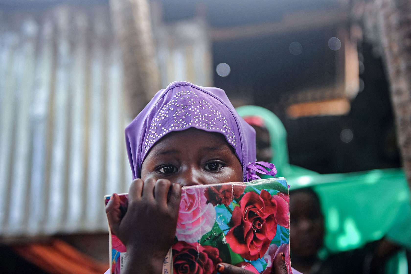 A displaced Somali girl attends a class to learn alphabets and numbers.