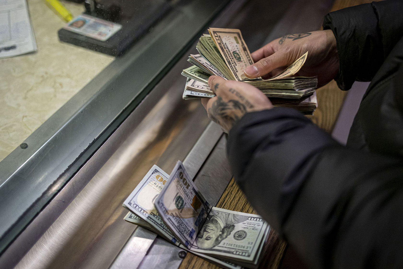 A man pays cash bail in the bond office of Division 5 of the Cook County Jail.