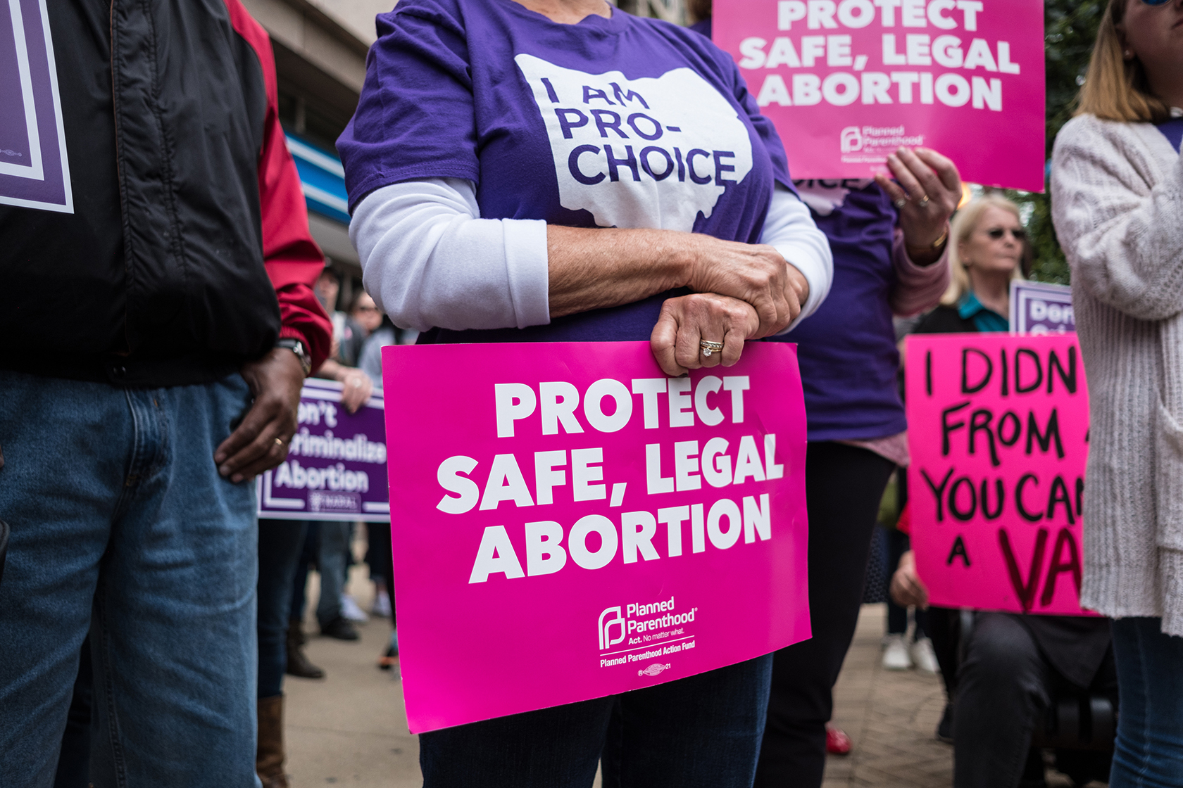 An activist seen holding a placard that says protect safe, legal abortion.