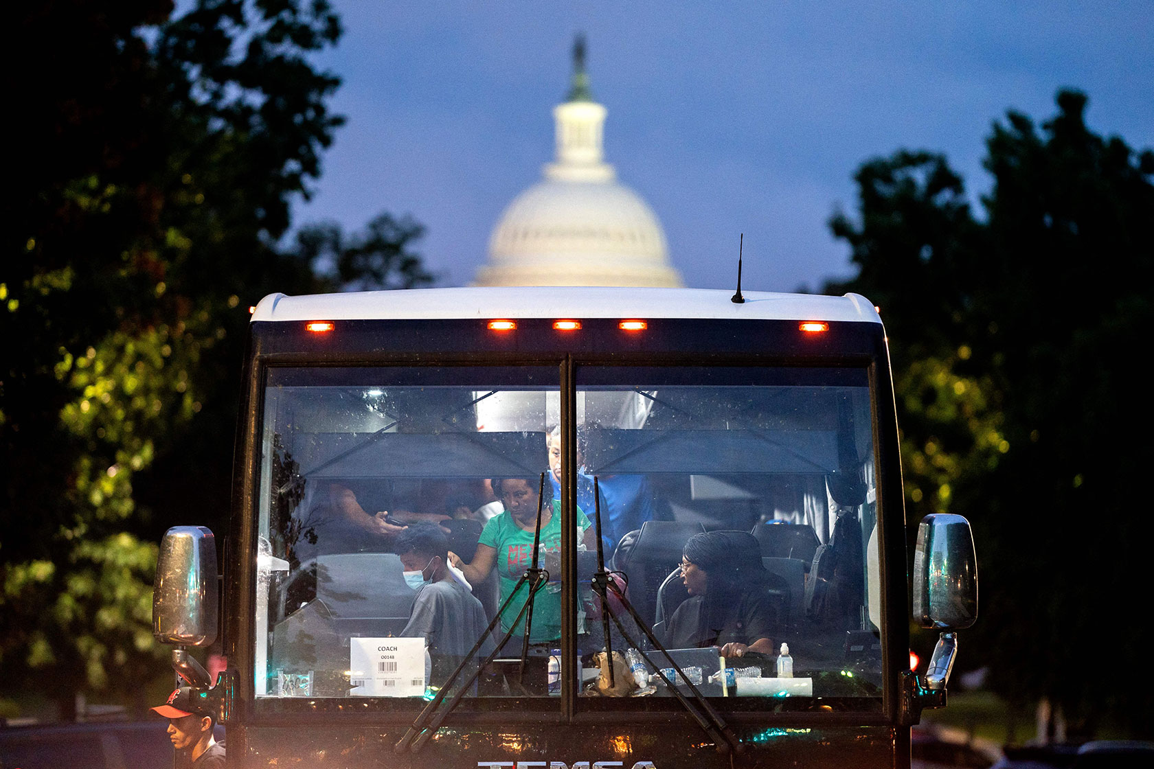 Migrants, who boarded a bus in Texas, are dropped off within view of the U.S. Capitol building.