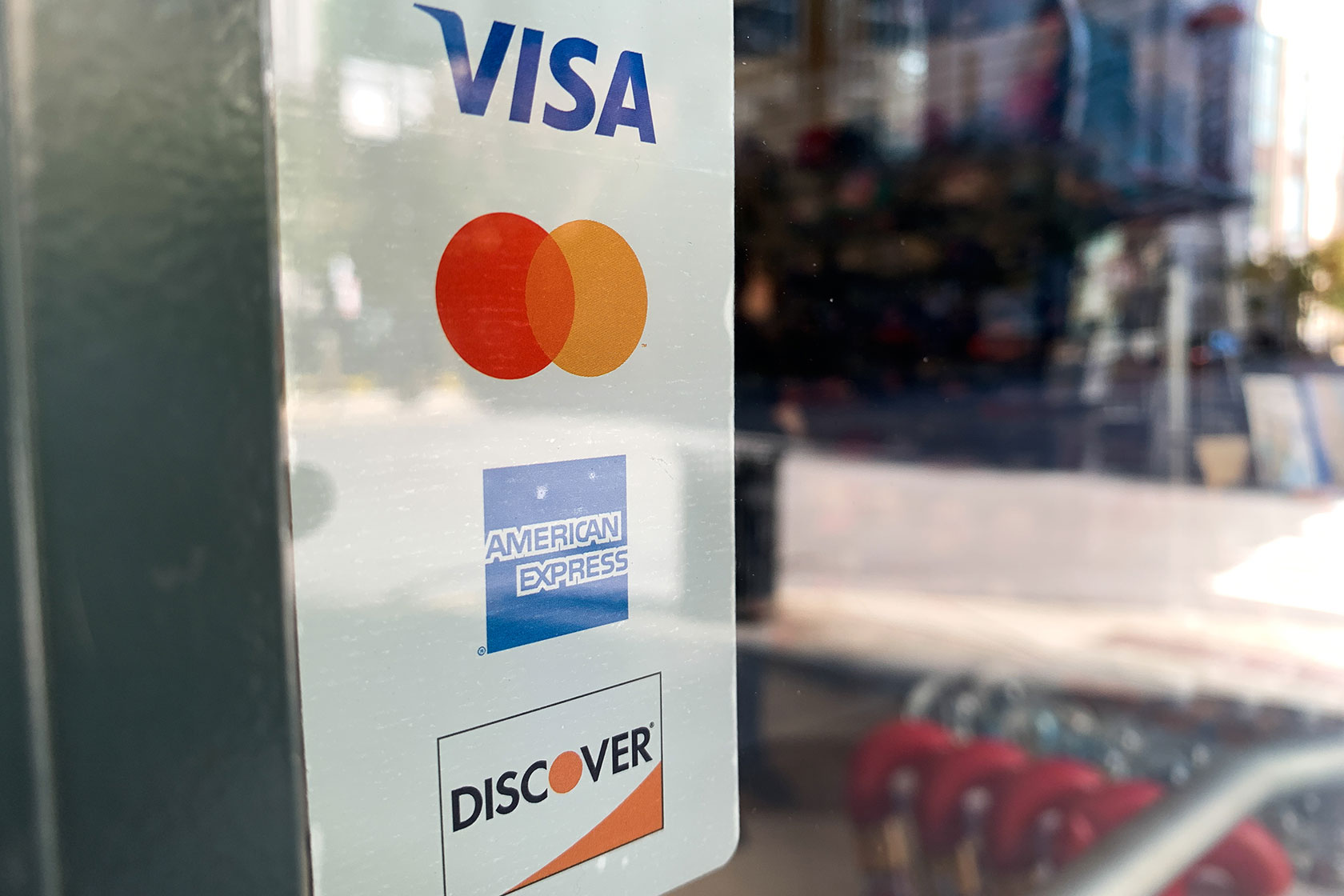 A sticker with credit card companies is seen at a shop in Chicago.