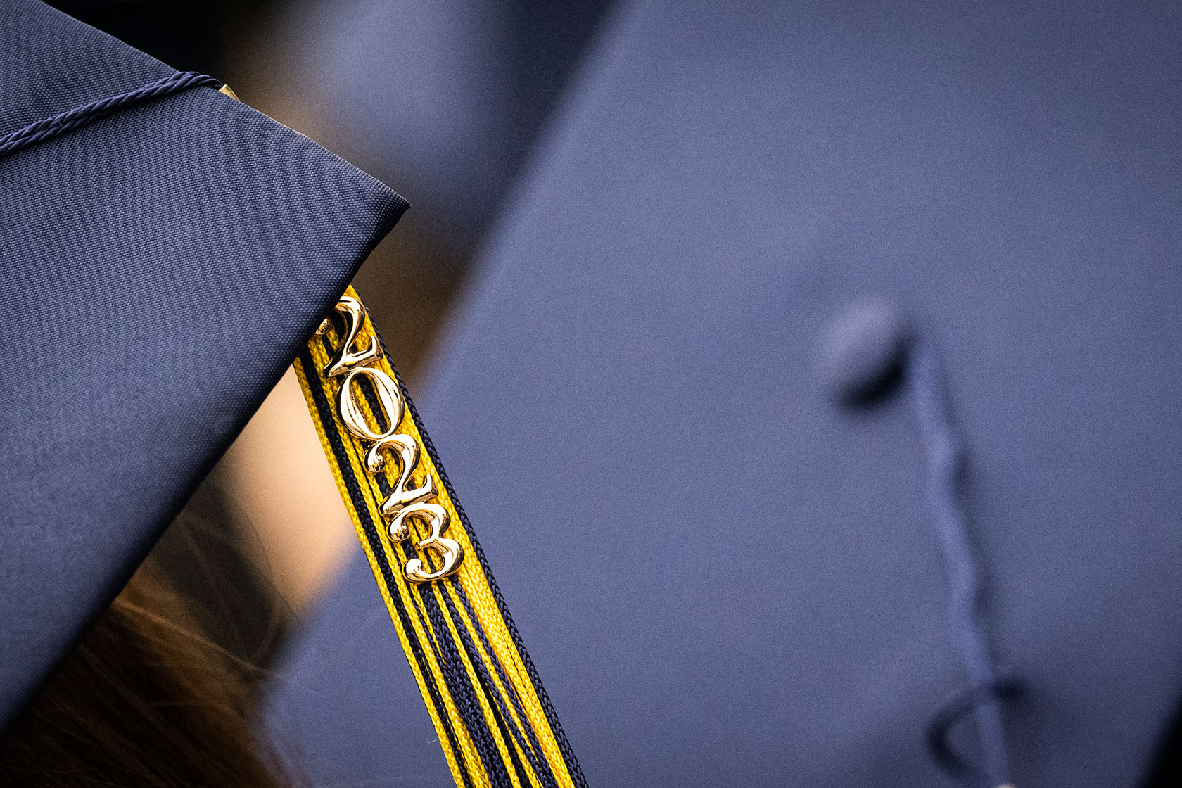 A “class of 2023” cap and tassel are seen.