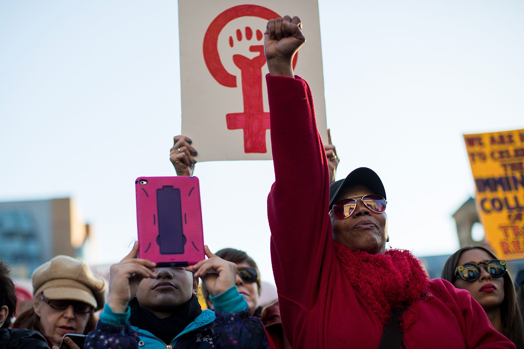 A woman holds up her fist during a rally to mark International Women's Day.