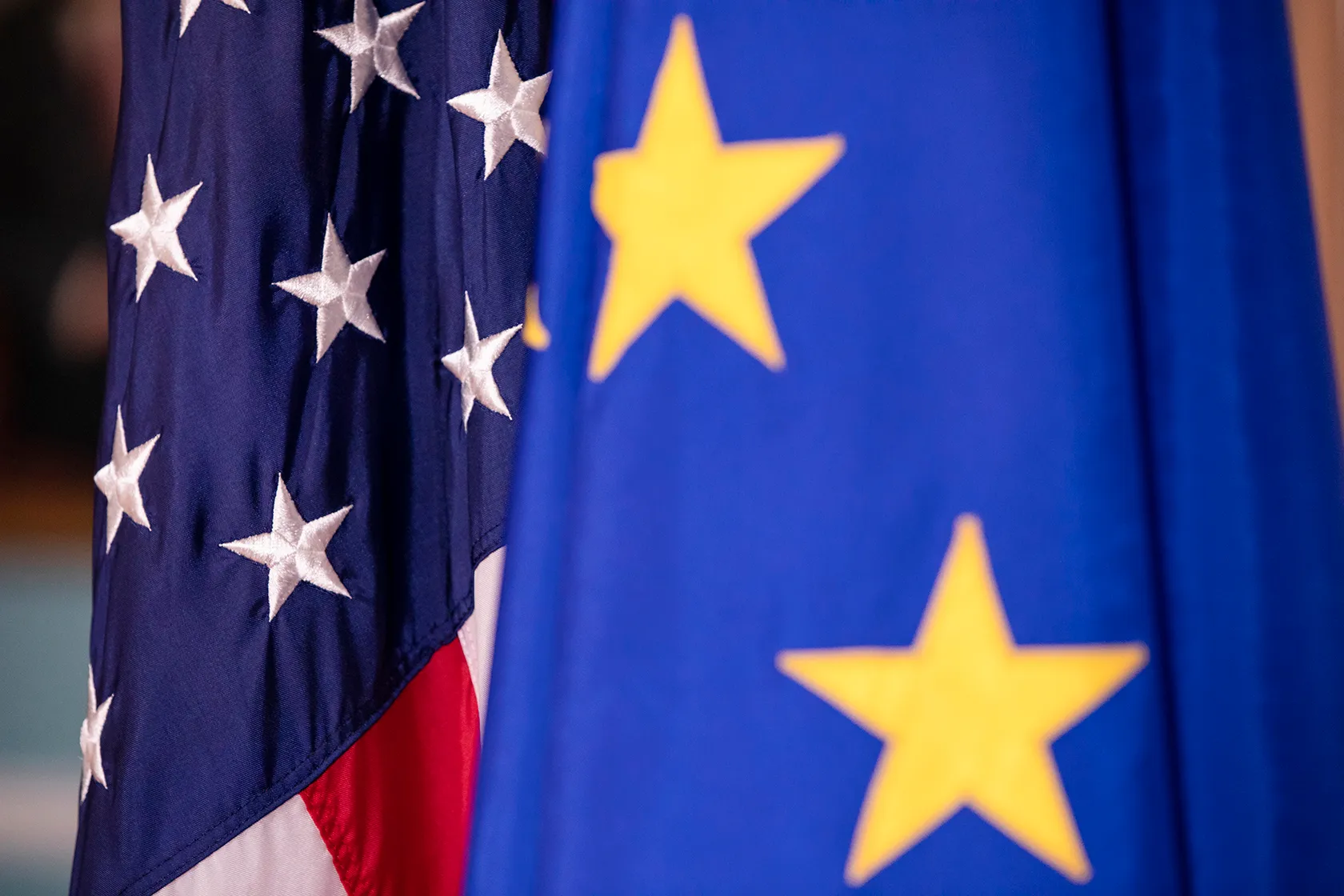 Close-up on EU and U.S. flags standing side by side