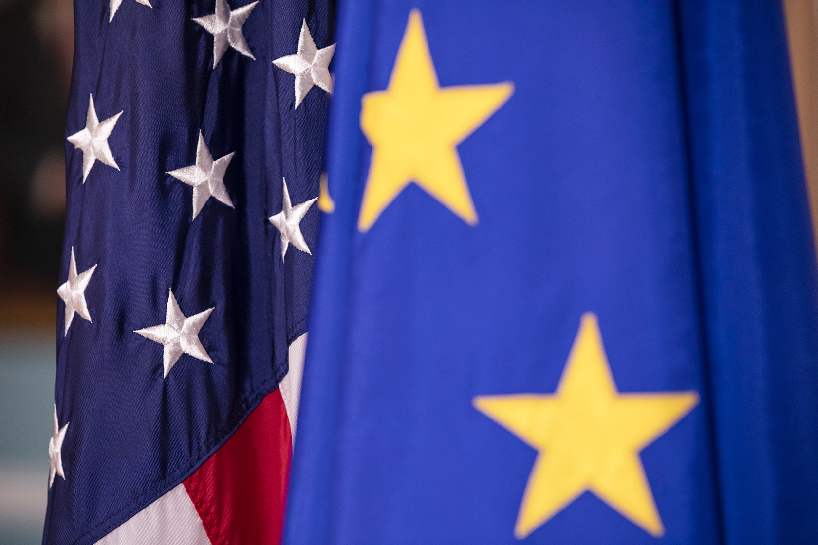 Close-up on EU and U.S. flags standing side by side