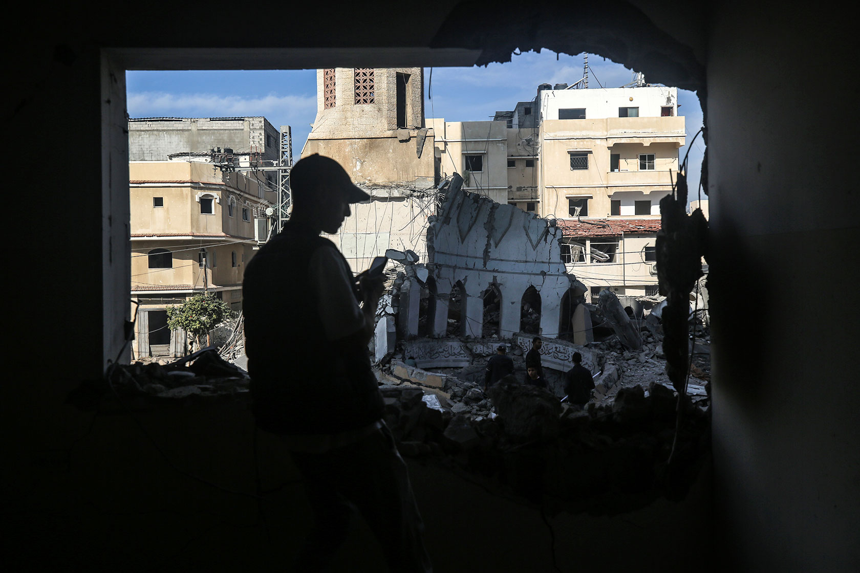 Palestinians inspect the debris at a mosque that was hit by an Israeli bombardment.
