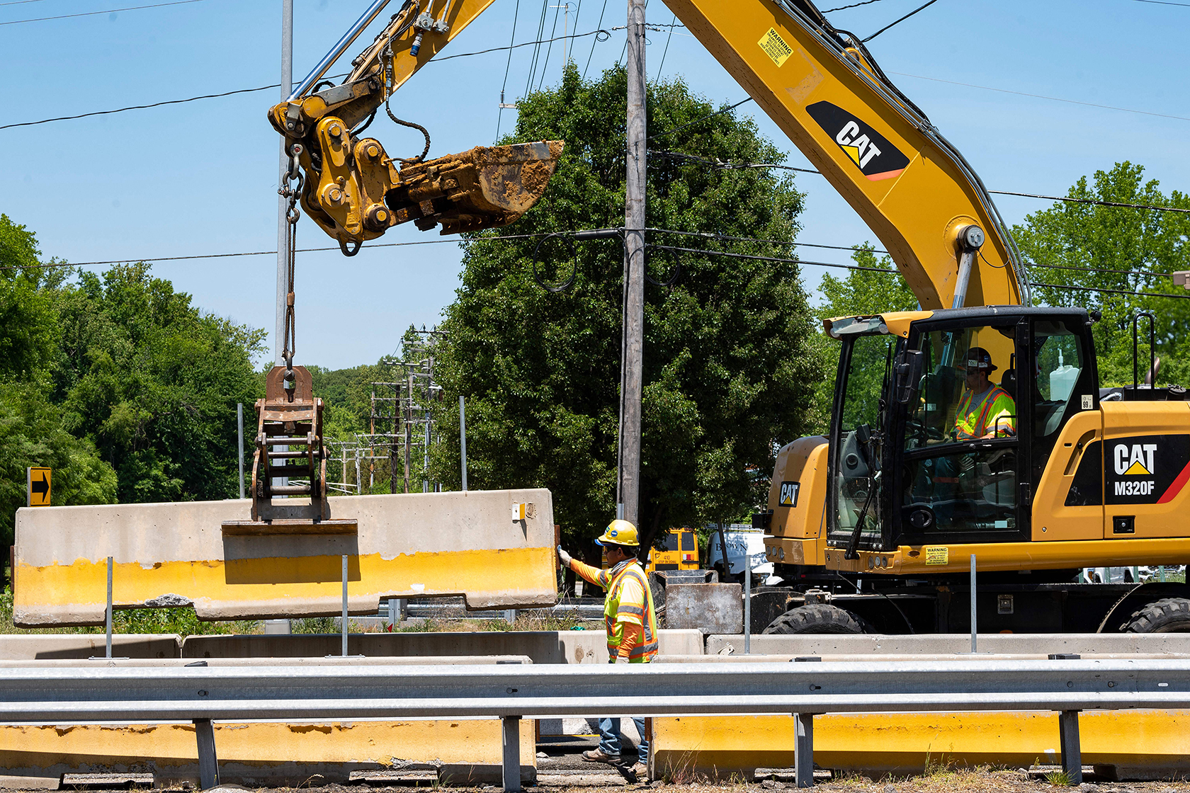 Construction workers using equipment