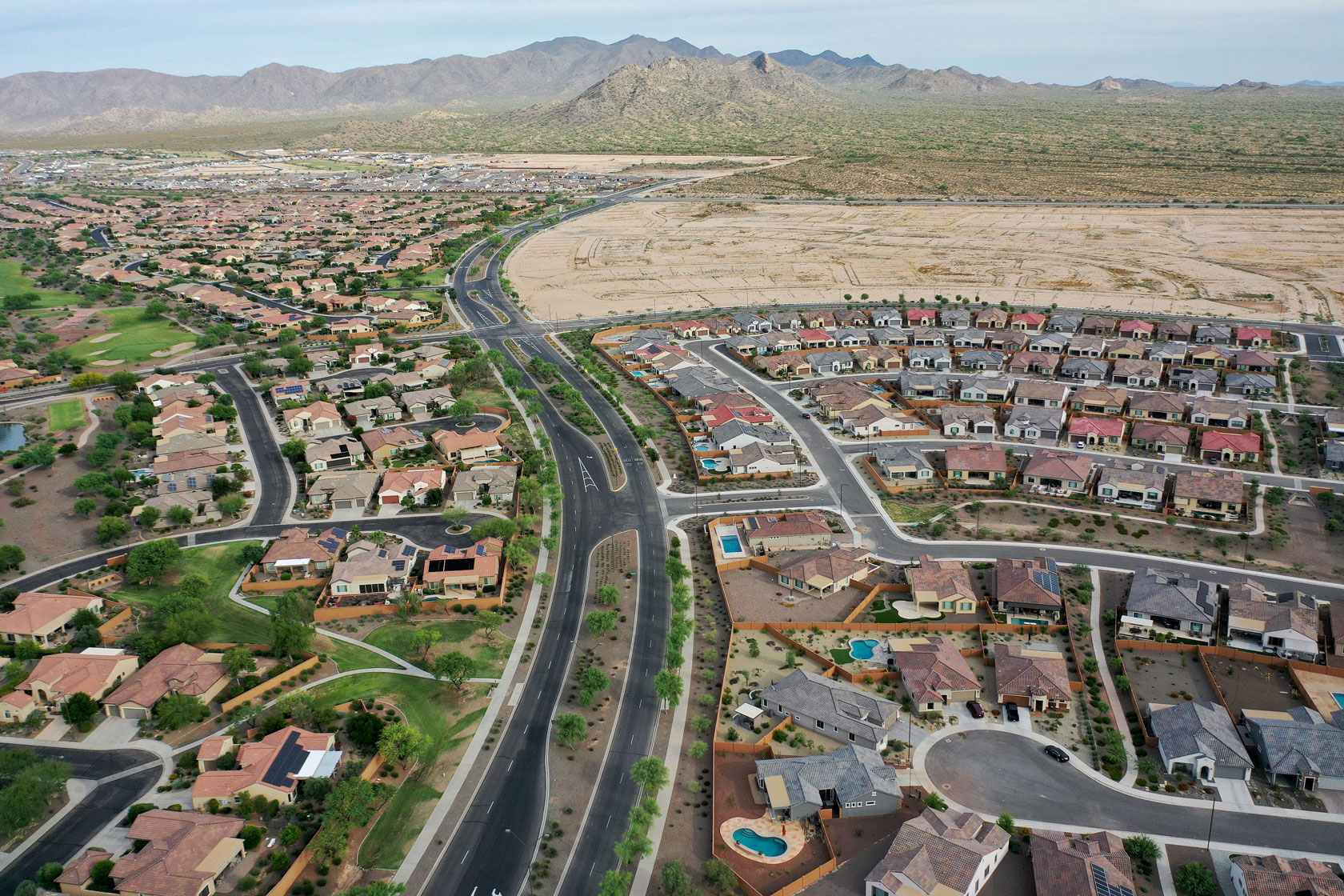 An aerial view of the city of Buckeye, Arizona, with mountains in the background.