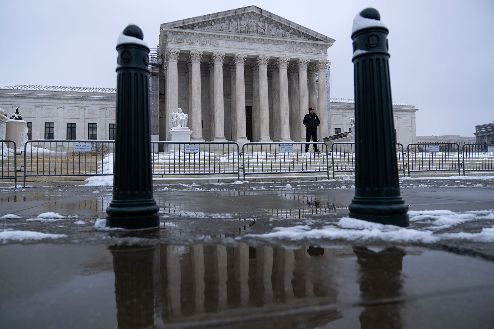 A security officer stands outside the U.S. Supreme Court building.