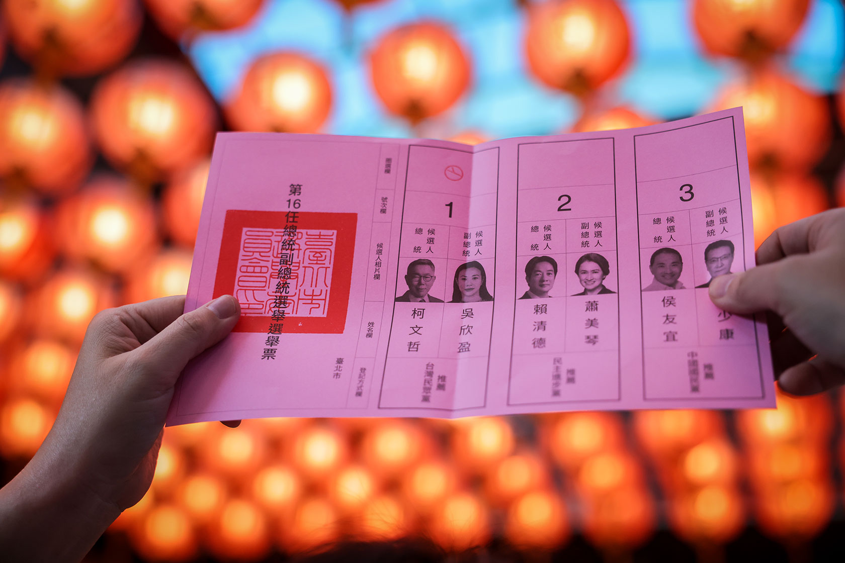 Election workers in Taipei count voting ballots.