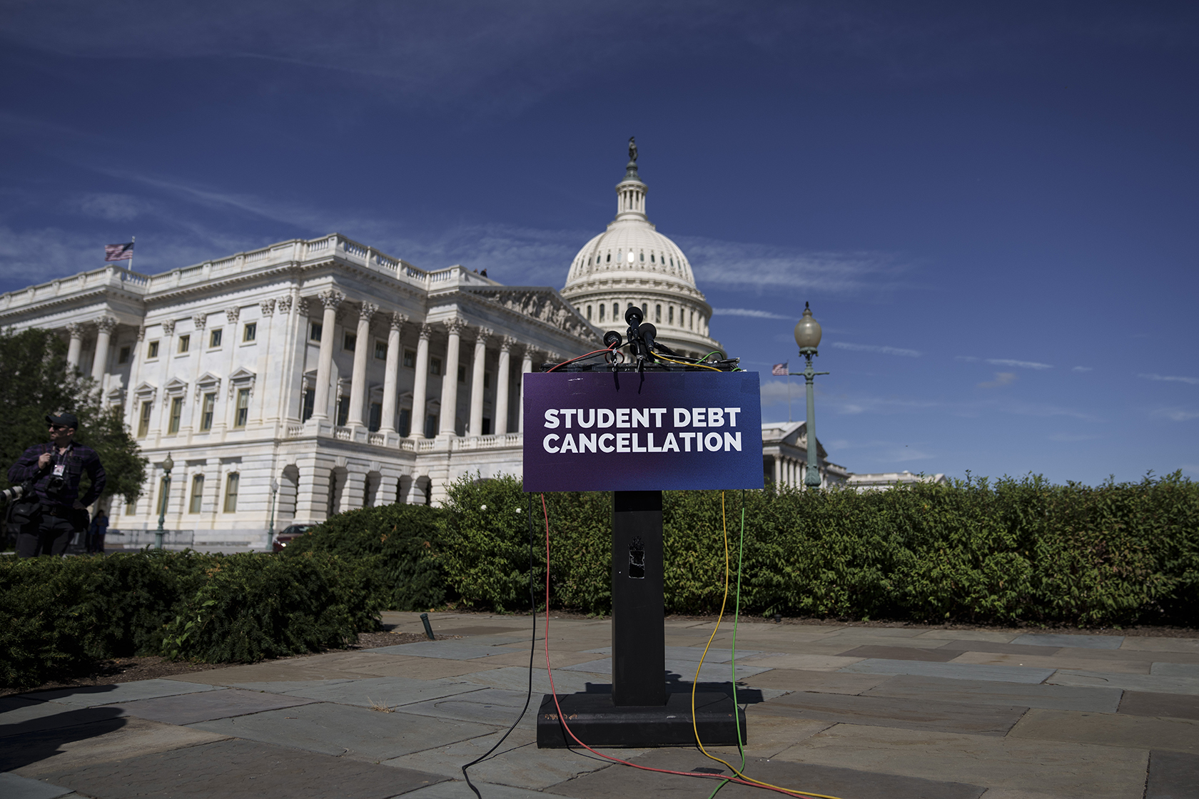 A podium in front of Capitol building, with placard reading 