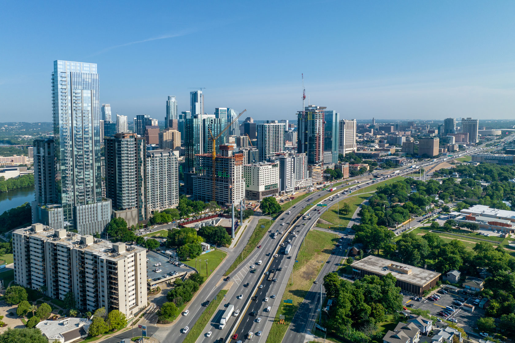 A highway is seen cutting through the middle of downtown Austin, Texas, with a river lying on the far left side.