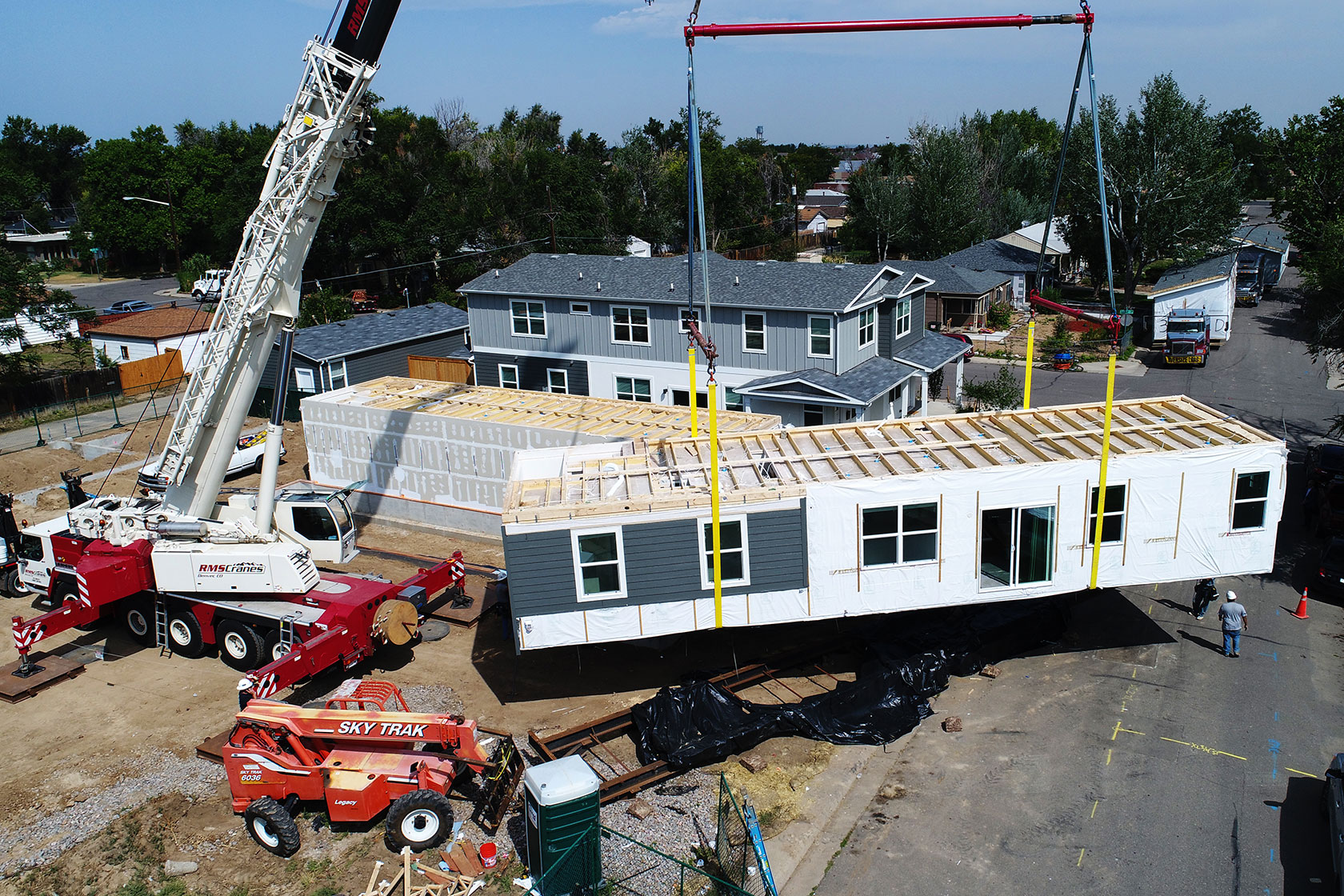 Crane lifting piece of a modular home