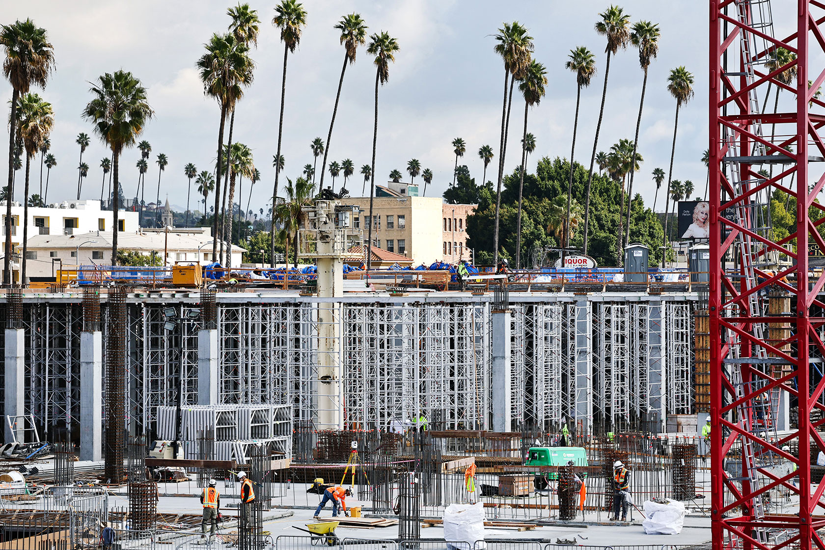 Construction of apartment complex with palm trees in background