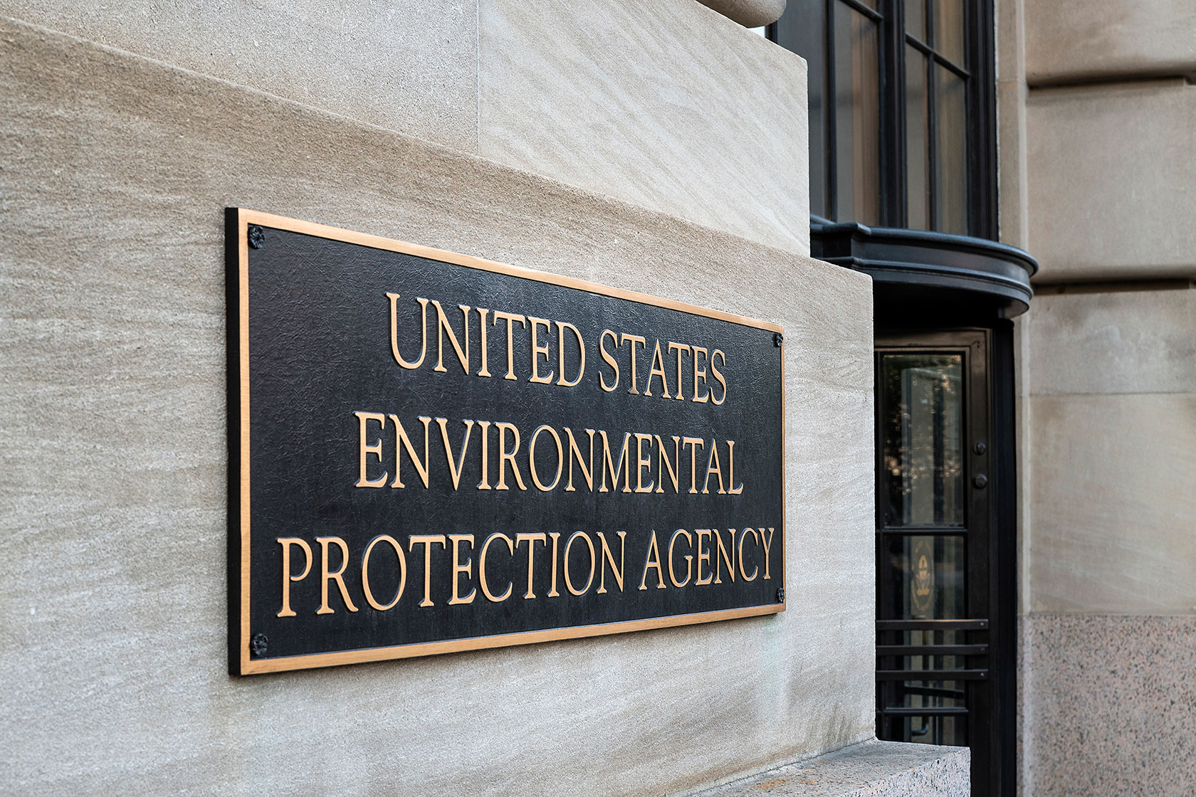 Photo shows a black plaque with gold lettering reading 