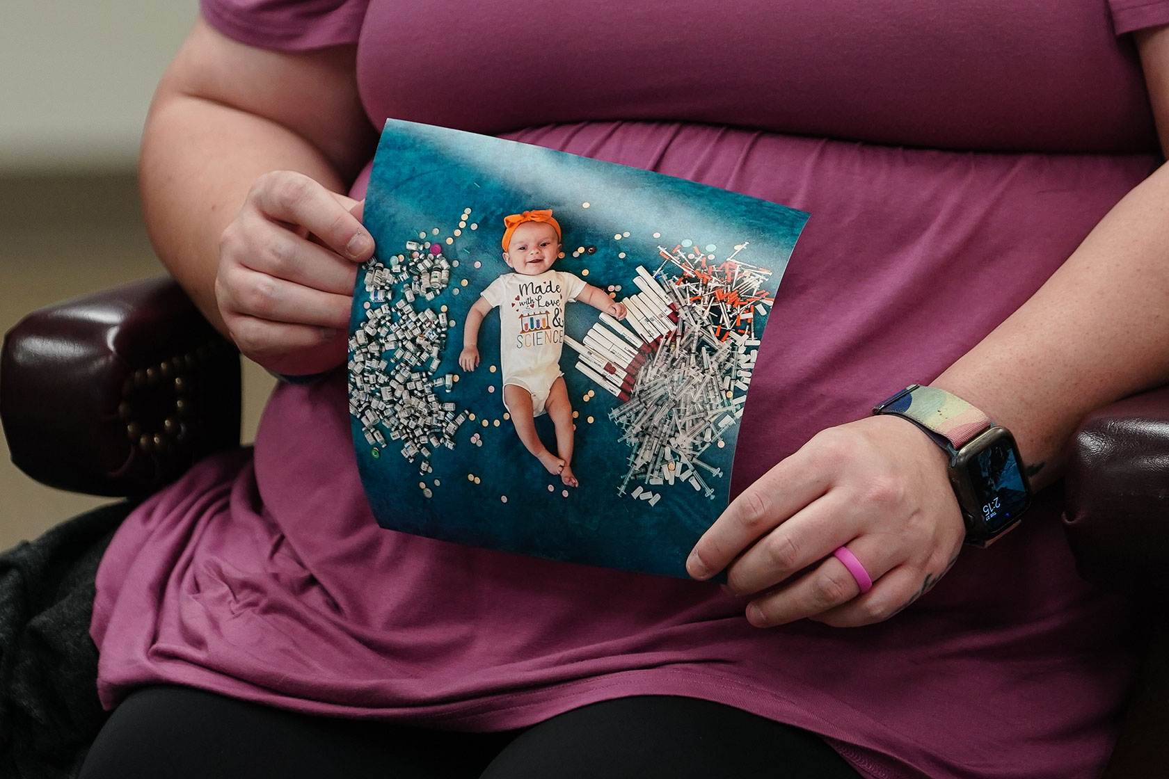 An in vitro fertilization (IVF) patient at the University of Alabama at Birmingham holds up a photo of her daughter.