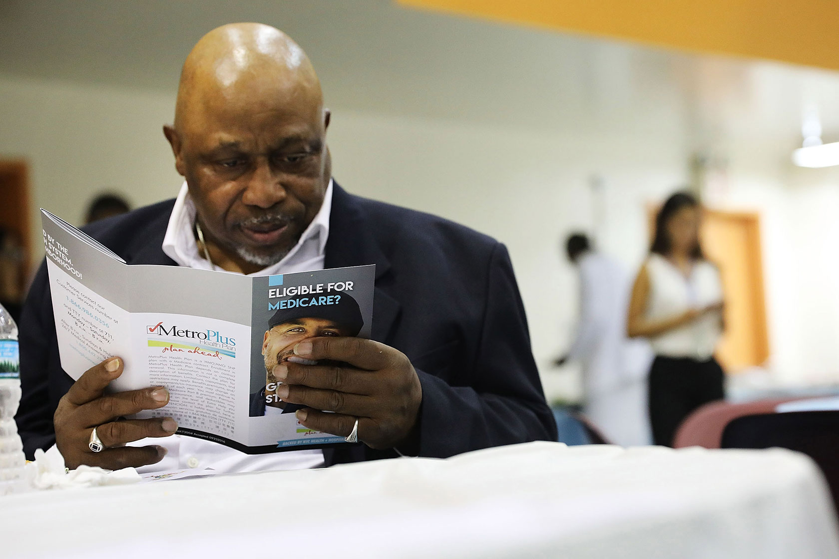 A man reads literature on Medicare at an event sponsored by MetroPlus in New York City.